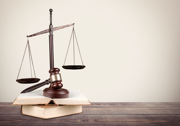 Golden scales of justice, gavel and books isolated on white