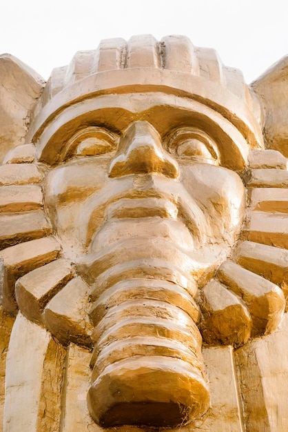 Golden sculpture of the sphinx background closeup