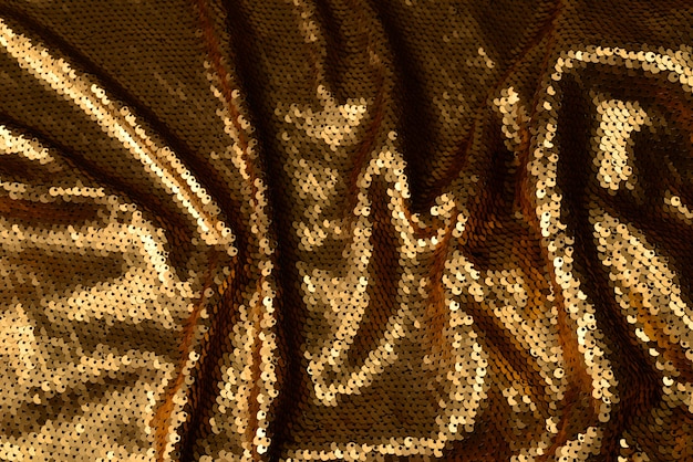 Golden sequins fabric texture.