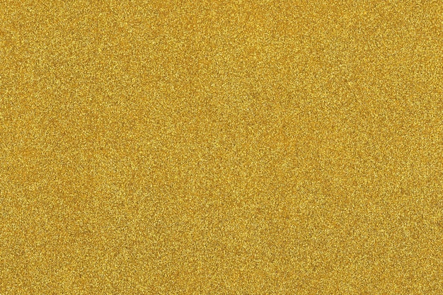 Golden shiny surface filled with shiny gold glitter