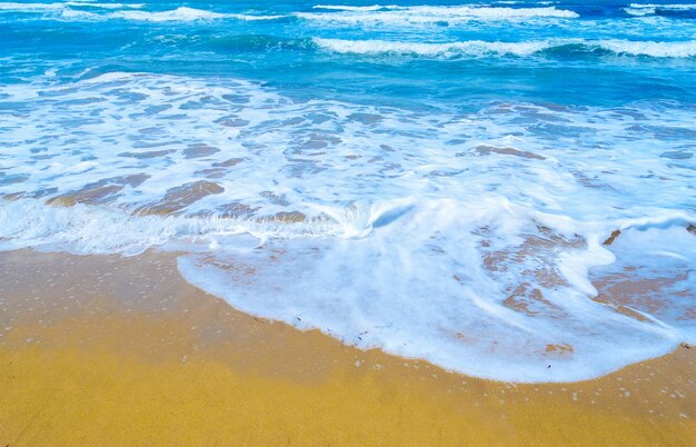 Golden shore and blue water in Sardinia Italy