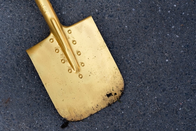A golden shovel is lying on the asphalt.Opening Ceremony.