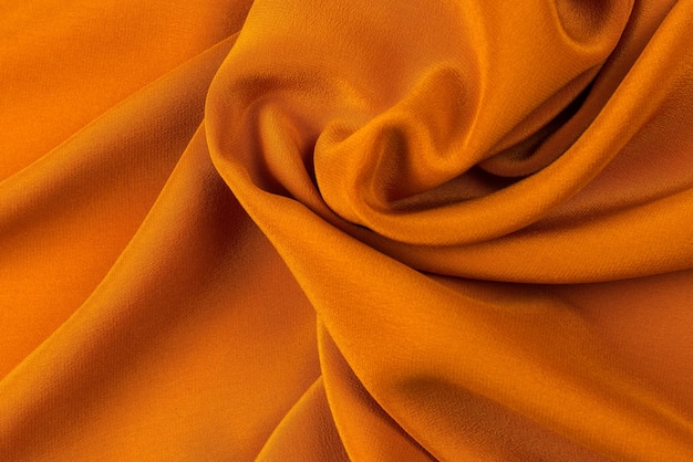 Golden silk or satin luxury fabric texture can use as abstract background