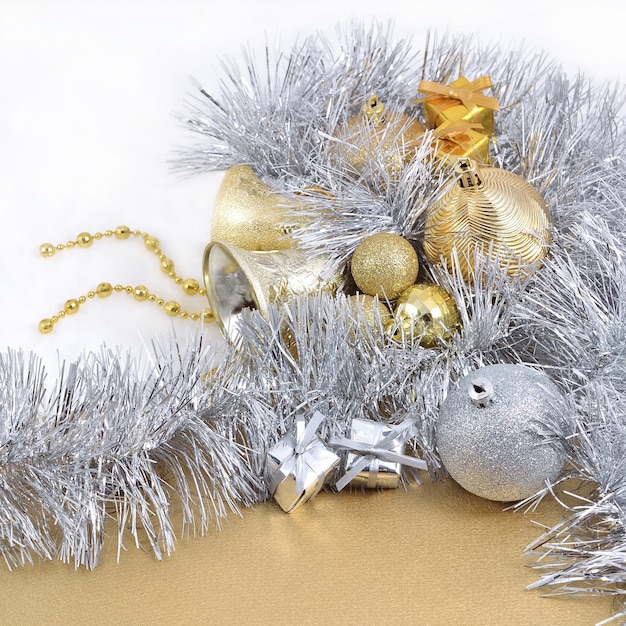 Golden and silver Christmas decorations on a white background