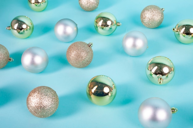 golden and silver christmas spheres on blue background