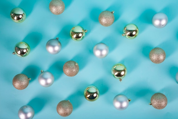 golden and silver christmas spheres on blue background
