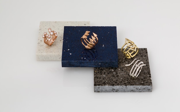 Golden and silver rings set on stone pieces