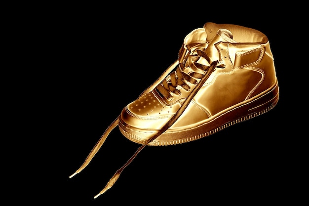 Golden sneaker on a black background