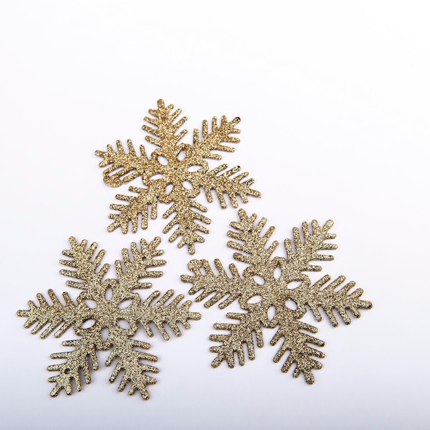 Golden snowflakes on a white square background