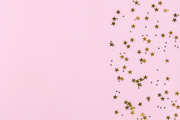 Golden sparkles on pink background