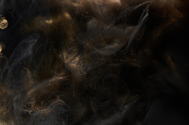 Golden sparkling abstract background luxury black smoke acrylic paint underwater explosion cosmic swirling ink