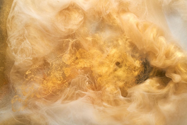 Golden sparkling abstract background luxury white smoke acrylic paint underwater explosion cosmic swirling ink