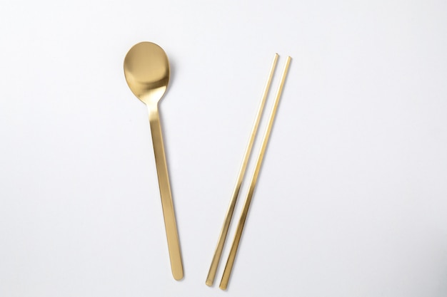 Golden spoon chopstick korea style on white 