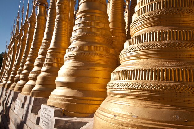 Golden stupas on Inle lake, traditional Buddhist architecture