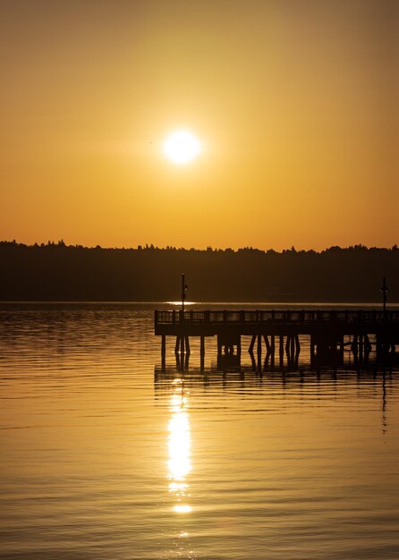 Golden sunrise over a hill reflecting on water