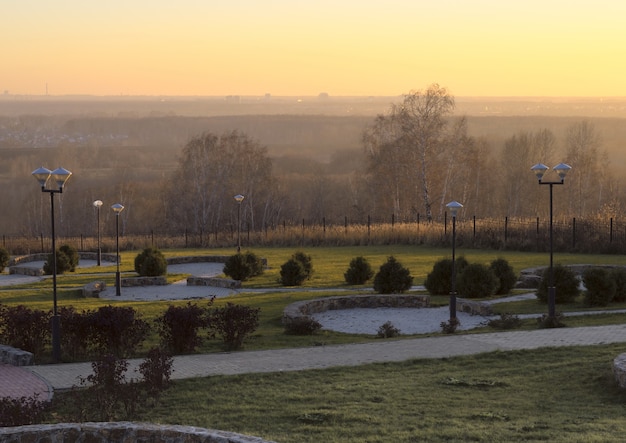 golden sunset over the park of the novosibirsk planetarium birches and forests on the horizon