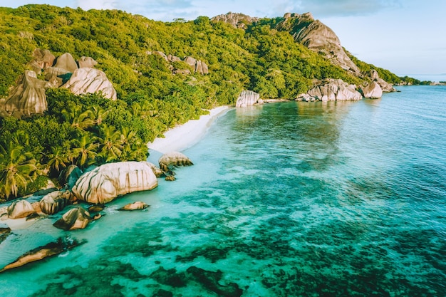 Golden sunset vibe colors at Anse Source D Argent exotic beach at Seychelles Aerial drone above