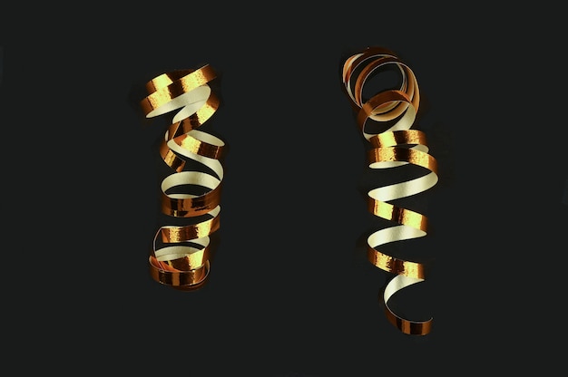 Golden swirling ribbons on black background. High quality photo