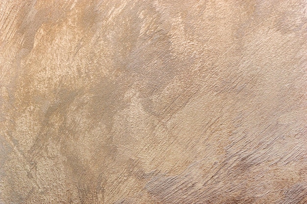 Golden texture of plastered wall as abstract background