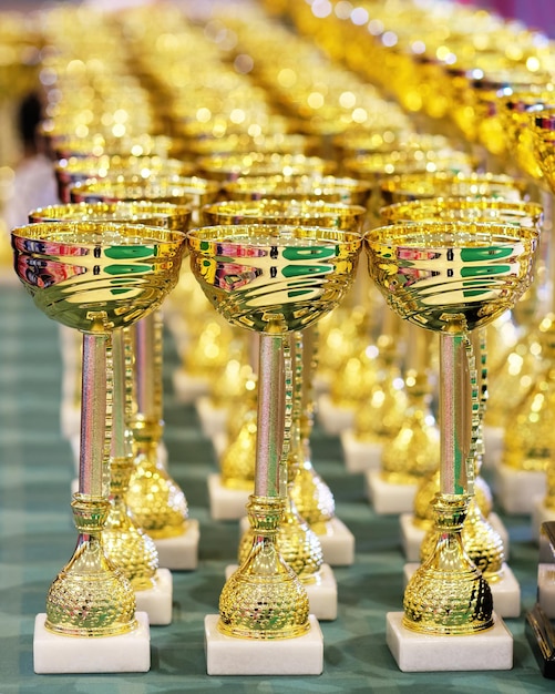 Golden trophies of champions gathered together Selective focus