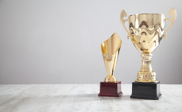 Golden trophy on white desk. Business, Success