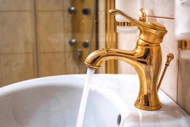 Golden vintage water tap in the bathroom