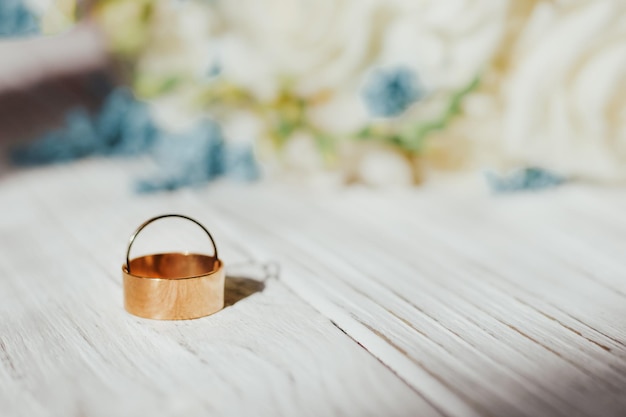 Golden wedding rings on the background of wooden figured boards