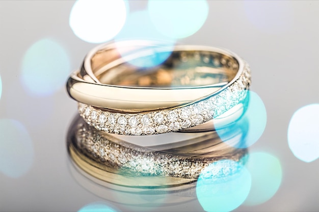 Golden wedding rings on bokeh background