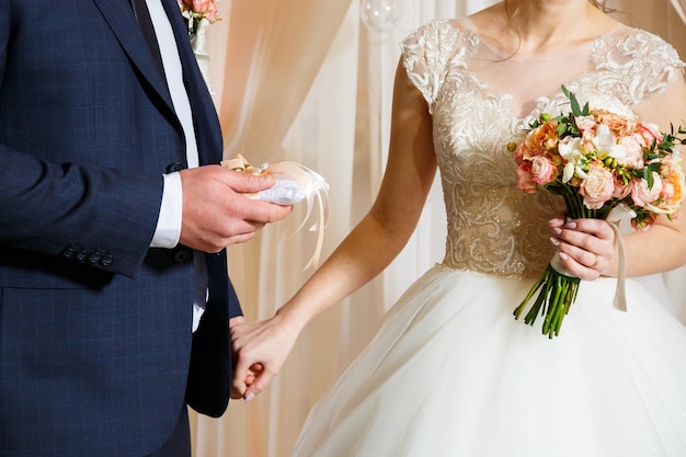 Golden wedding rings for newlyweds on their wedding day