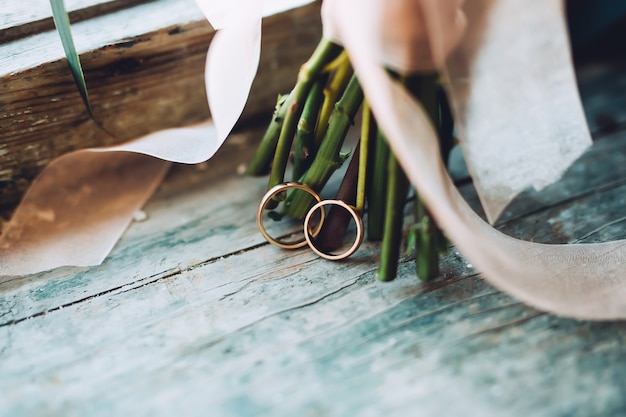 Golden wedding rings on old blue wooden table