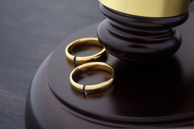 Golden wedding rings with a crack and judge gavel