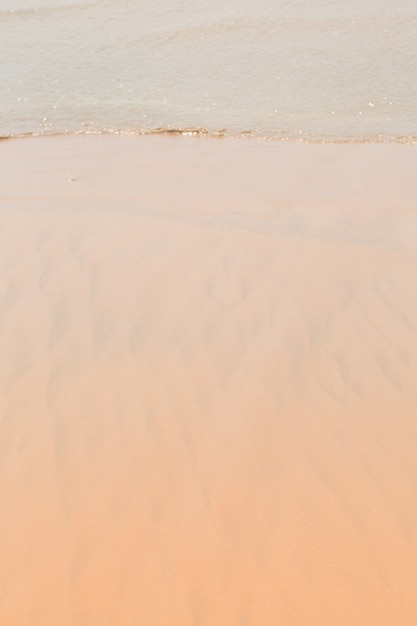 Golden wet sand in the ocean