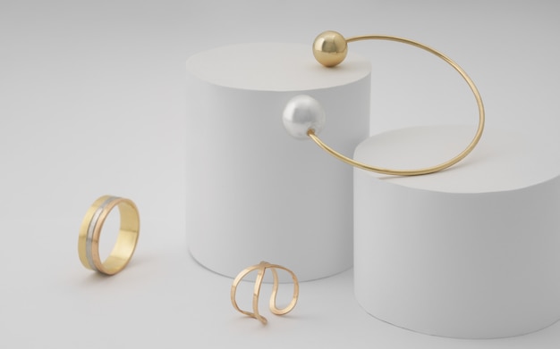 Golden with pearl bracelet and golden rings on white round platform on white surface