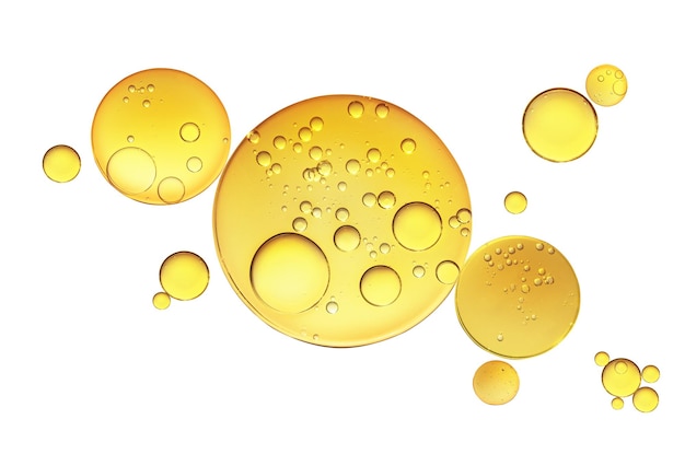 Golden yellow abstract oil bubbles or face serum isolated on white background