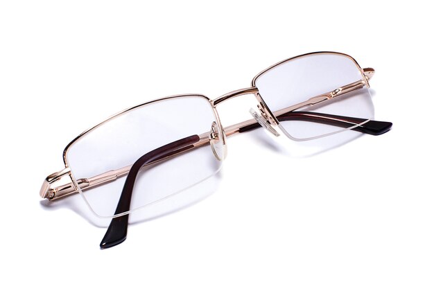 Goldrimmed eyeglasses on white background