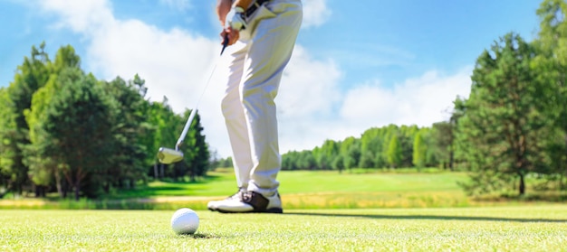 Golf approach shot with iron from fairway at sunny day