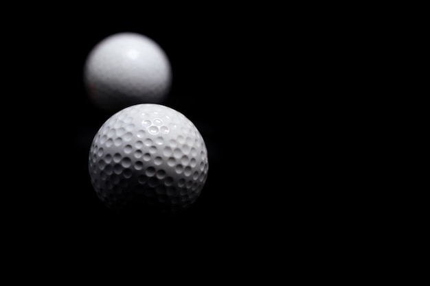 Golf ball on black background