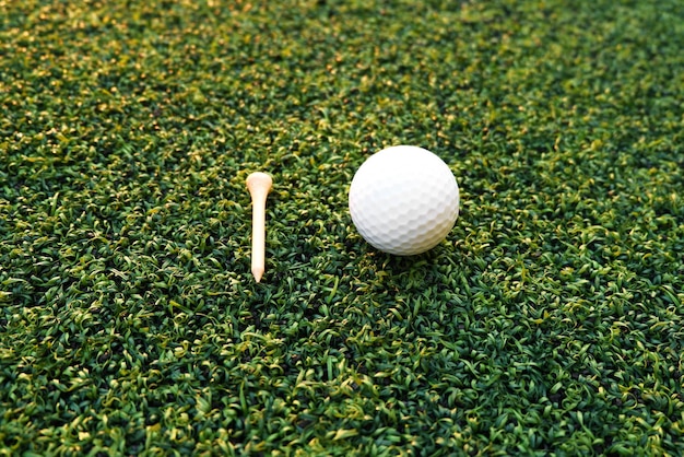 Golf ball close up on green grass on blurred beautiful\
landscape of golf backgroundconcept international sport that rely\
on precision skills for health relaxationx9