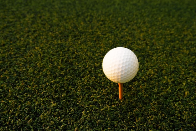 Golf ball close up on green grass on blurred beautiful\
landscape of golf backgroundconcept international sport that rely\
on precision skills for health relaxationx9