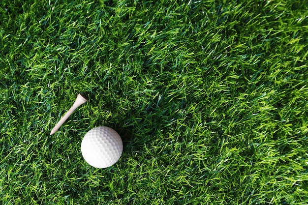 Golf ball close up on green grass on blurred beautiful\
landscape of golf backgroundconcept international sport that rely\
on precision skills for health relaxationx9