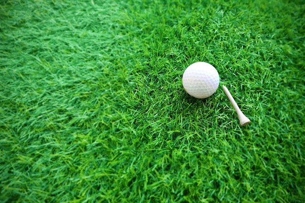 Golf ball close up on green grass on blurred beautiful\
landscape of golf backgroundconcept international sport that rely\
on precision skills for health relaxationx9