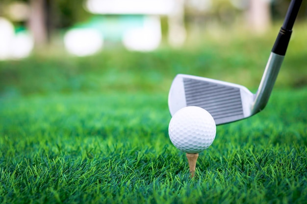 Golf ball close up on tee grass on blurred beautiful landscape of golf background Concept internati