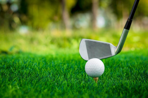 Golf ball close up on tee grass on blurred beautiful landscape of golf background Concept international sport that rely on precision skills for health relaxation
