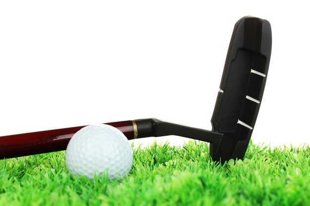 Golf ball and driver on grass isolated on white