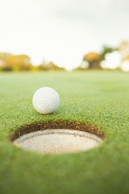 Golf ball at the edge of the hole