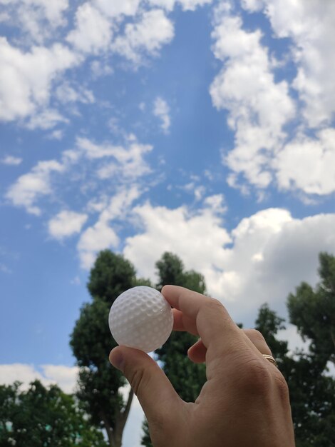 Golf ball in a man39s hand in nature