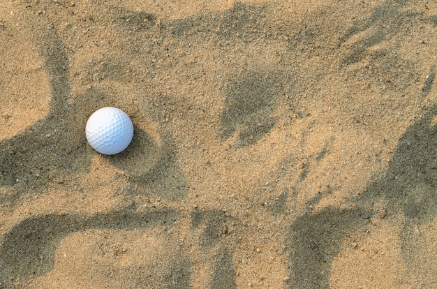 A golf ball on the sand 