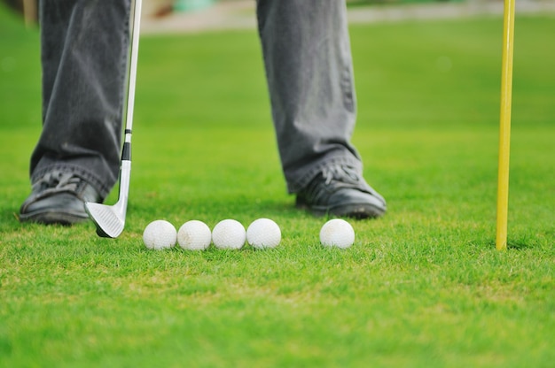 Golf ball on sports golf course and hole