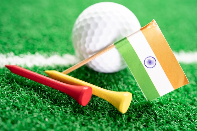 Golf ball with india flag and tee on green lawn or grass is\
most popular sport in the world