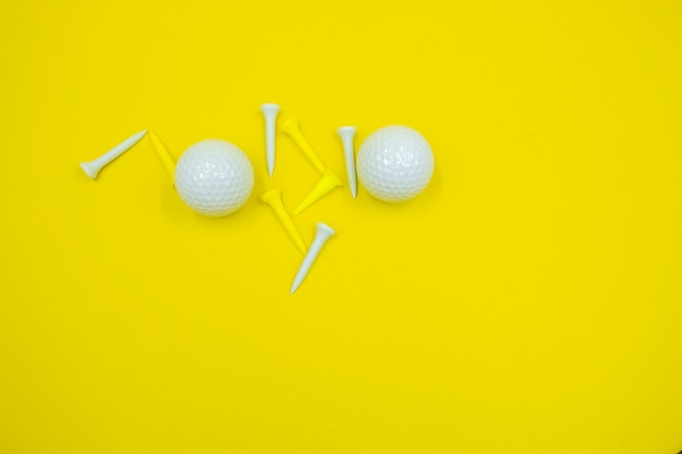 Golf ball and yellow tees